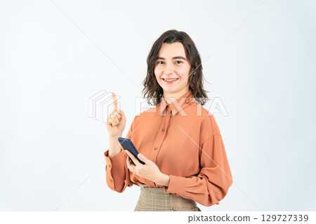 A white woman holding a smartphone and giving directions A white woman holding a smartphone and giving directions 129727339