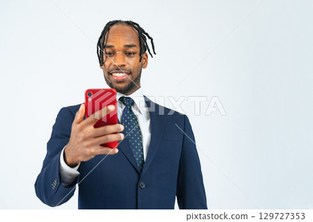 Black male business person using a smartphone Black male business person using a smartphone 129727353