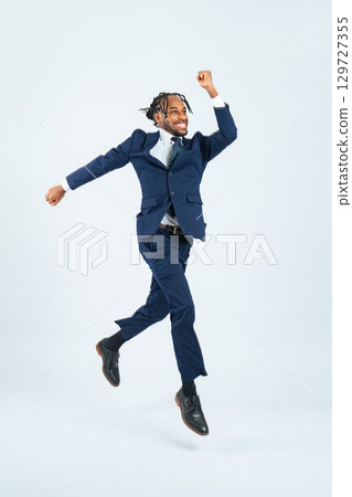 Full body photo of a jumping black businessman Full body photo of a jumping black businessman 129727355