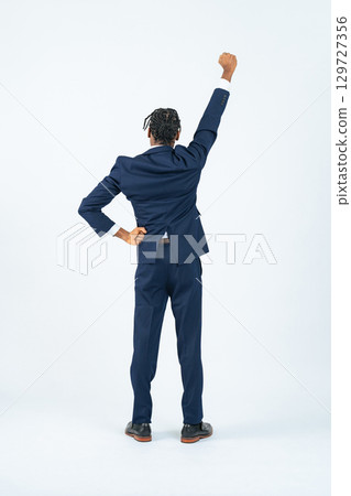 Full-body photo of a black male business person posing in a fist pump Full-body photo of a black male business person posing in a fist pump 129727356