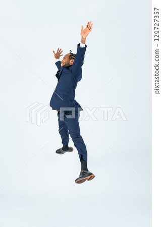 Full body photo of a jumping black businessman 129727357
