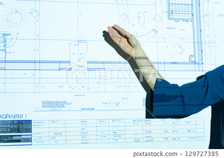 A woman giving a presentation using a projector 129727385