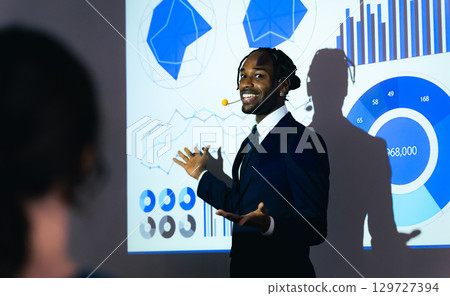 Black man giving a presentation using a projector Black man giving a presentation using a projector 129727394