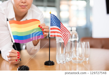 Flags of United States and LGBT on negotiating table Flags of United States and LGBT on negotiating table 129727548