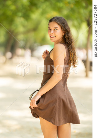 Woman walking in the park in summer 129727594