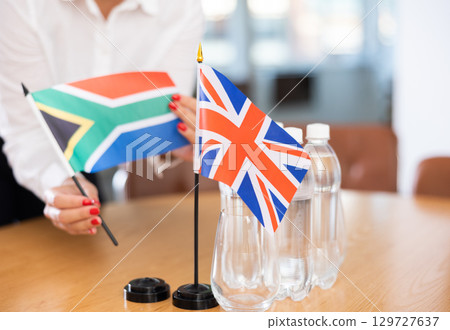 Flags of United Kingdom and South Africa on table in meeting room 129727637