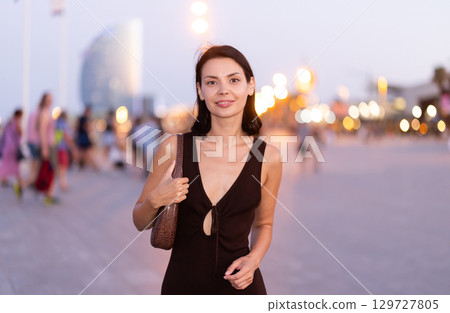 Young woman walking on a lively promenade of Barceloneta Young woman walking on a lively promenade of Barceloneta 129727805