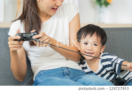 Playful Moments: Mother and Child Enjoying Video Games 129727953