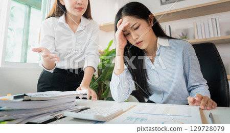 Workplace Stress. Employee experiencing anxiety during a tense meeting with manager. 129728079