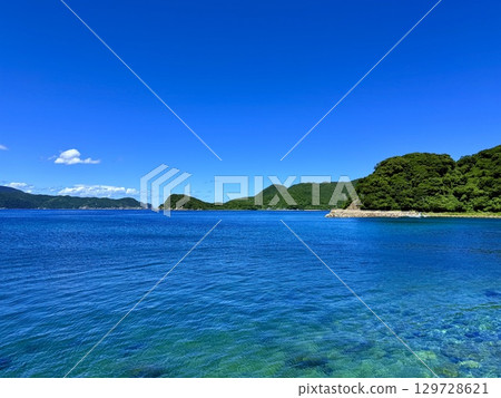 View of the sea and villages on Naru Island in the Goto Islands, Nagasaki Prefecture, with crystal clear waters and a calm summer landscape 129728621