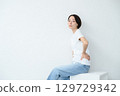 A woman sitting 129729342