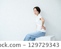 A woman sitting 129729343