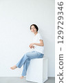 A woman sitting 129729346