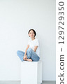 A woman sitting 129729350