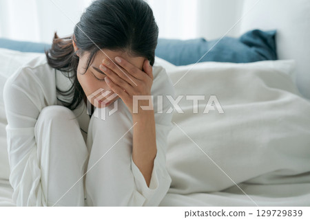 A woman waking up with a tired look 129729839