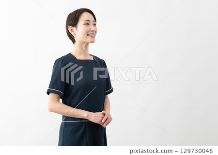 Young woman wearing beauty salon uniform Beauty image 129730048