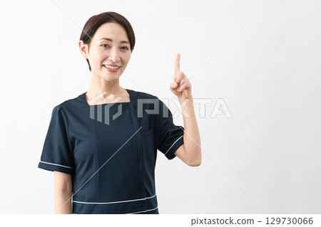 Young woman wearing beauty salon uniform Beauty image 129730066