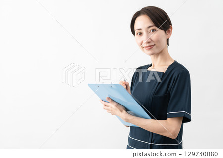 Young woman wearing beauty salon uniform Beauty image 129730080