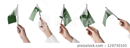 The Pakistan flag in hand in different angles on a white background 129730105