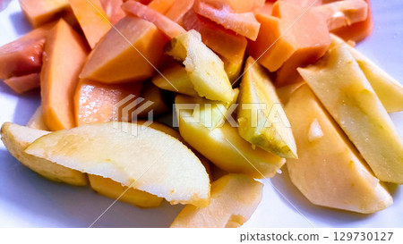 Freshly Cut Ripe Papaya Slices on a Plate 129730127