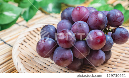 Pione grapes served on a bamboo colander 129730651