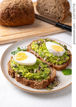 Avocado toast with boiled egg, sunflower seed, pumpkin seed and sesame seeds, Healthy eating Avocado toast with boiled egg, sunflower seed, pumpkin seed and sesame seeds, Healthy eating 129730716