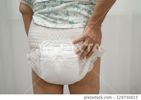 Asian senior woman patient wearing adult incontinence diaper pad in hospital. Asian senior woman patient wearing adult incontinence diaper pad in hospital. 129730823