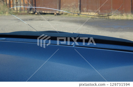 Cracks in the windshield of a car caused by flying stones Cracks in the windshield of a car caused by flying stones 129731594