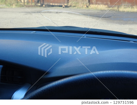 Cracks in the windshield of a car caused by flying stones Cracks in the windshield of a car caused by flying stones 129731596