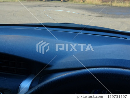 Cracks in the windshield of a car caused by flying stones Cracks in the windshield of a car caused by flying stones 129731597