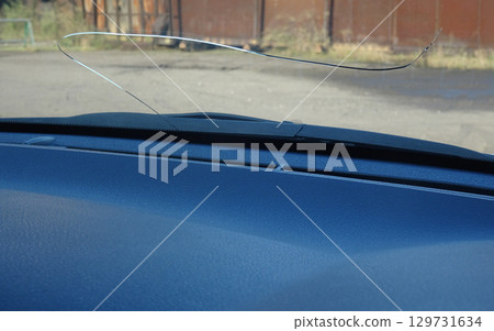 Cracks in the windshield of a car caused by flying stones Cracks in the windshield of a car caused by flying stones 129731634