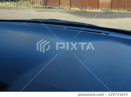 Cracks in the windshield of a car caused by flying stones Cracks in the windshield of a car caused by flying stones 129731635