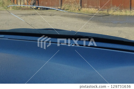 Cracks in the windshield of a car caused by flying stones Cracks in the windshield of a car caused by flying stones 129731636