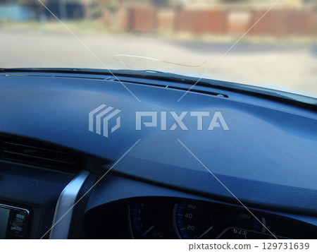 Cracks in the windshield of a car caused by flying stones 129731639