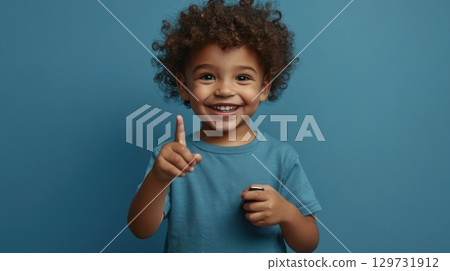 happy child holding object and pointing up happy child holding object and pointing up 129731912
