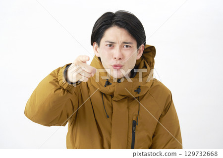 A man wearing a down jacket scolds on a white background 129732668