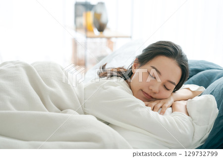 A young woman sleeping in bed A young woman sleeping in bed 129732799