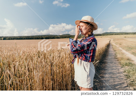 Woman in a Wheat Field, Examining Crop with Clipboard Woman in a Wheat Field, Examining Crop with Clipboard 129732826