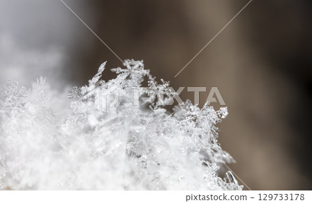 Macro snowflakes showing intricate winter details on dark background 129733178
