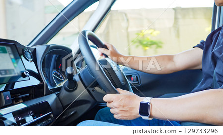 Image of a man driving a car 129733296