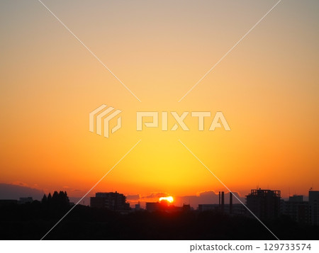 The sun setting over the city The sun setting over the city 129733574