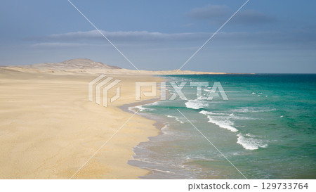 Panorama from above of a sandy beach and mighty waves of the Atlantic Ocean 129733764