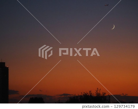 The moon at 2.6 days old floating in the evening sky The moon at 2.6 days old floating in the evening sky 129734179