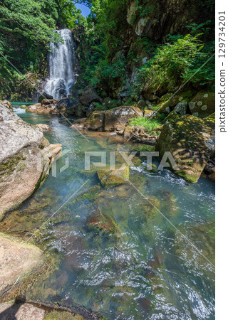 A waterfall that creates a beautiful river flow 129734201