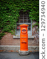 Red mailbox, bricks and green vines 129734940