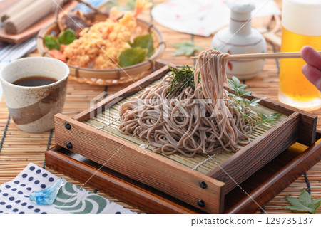 Tempura soba noodles and cold beer. Summer Japanese lunch. Zaru soba noodles with tempura. For advertising, menus, and restaurants. Tempura soba noodles and cold beer. Summer Japanese lunch. Zaru soba noodles with tempura. For advertising, menus, and restaurants. 129735137