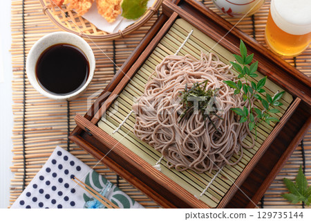 Tempura soba noodles and cold beer. Summer Japanese lunch. Zaru soba noodles with tempura. For advertising, menus, and restaurants. 129735144