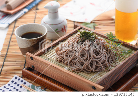 Tempura soba noodles and cold beer. Summer Japanese lunch. Zaru soba noodles with tempura. For advertising, menus, and restaurants. 129735145