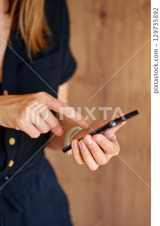 Woman using smartphone at home 129735892