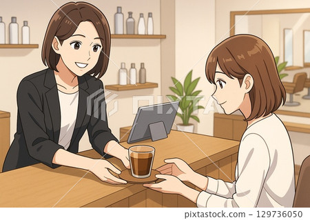 美容院接待處的工作人員為顧客提供飲料 美容院接待處的工作人員為顧客提供飲料 129736050